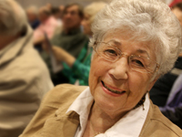 Older woman smiling at a Dakota County Library program.
