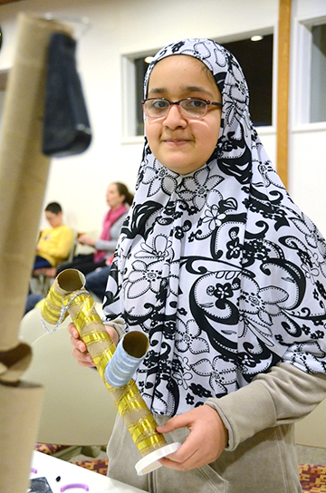 Girl holding a STEM project.
