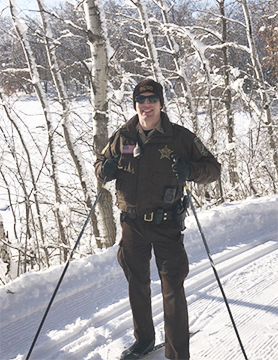 Park ranger skiing on Dakota County trail.