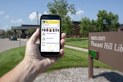 Hand holding mobile device with Library mobile app on the screen.