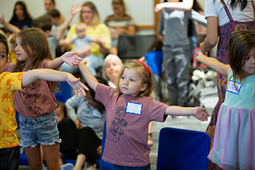 Girl dancing at library program.