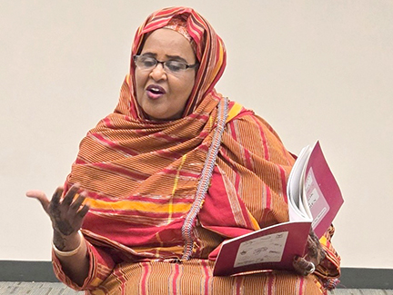 Fardousa reads a story to a group of children.