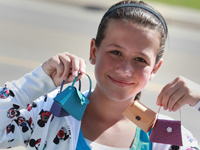 Girl holding craft mini-purses.