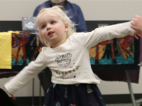 Child dancing at a library event.