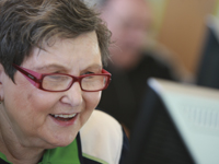 A woman looking at a computer screen.