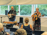 A guitar player and banjo player performing at a Dakota County Library.