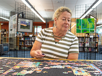 Woman putting together a puzzle.