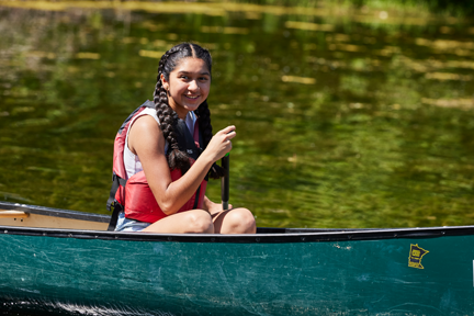 Girl smiling while canoeing at Lebanon Hills Regional Park.