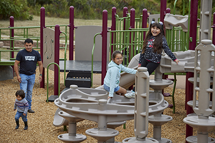 Family using playground equipment.