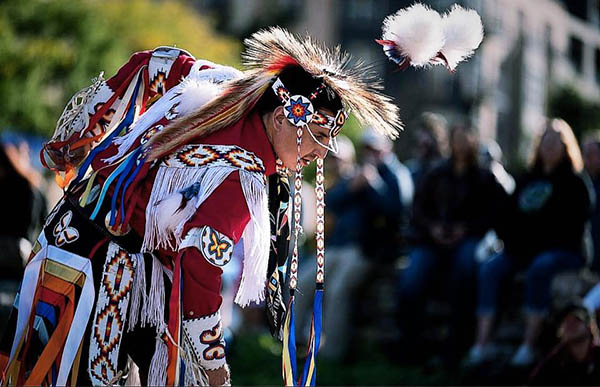 A Native dancer performing in front of a crowd.