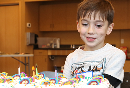 Boy smiling at his birthday Party