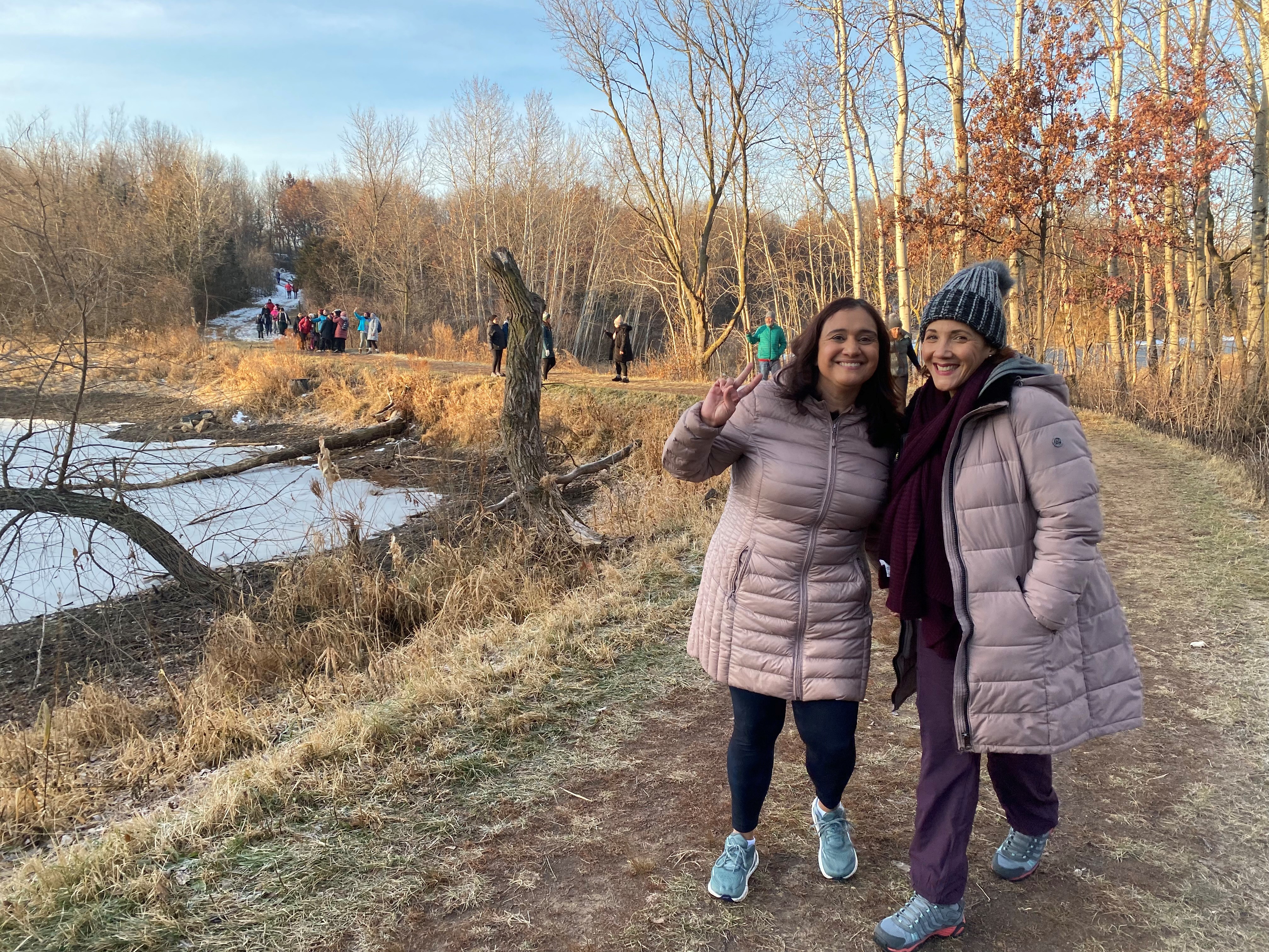 Two women smiling during a Spanish-language program. 