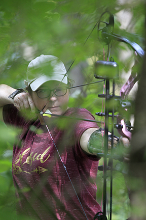 Woman aiming her bow.
