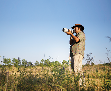 Man focusing his camera at a Dakota County Park.