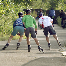 Three men inline skating on Big RIvers Regional Trail.