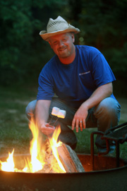 Man sitting at bonfire.