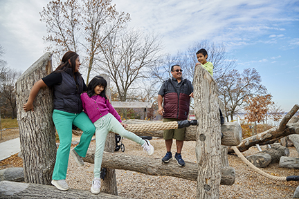 Family of four on Lake Byllesby Regional Park play area.