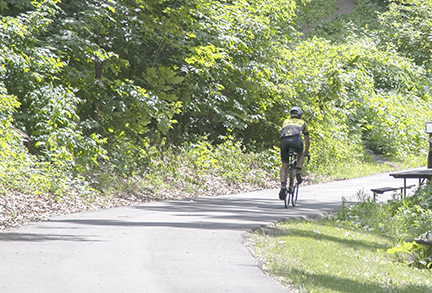 Biker on the River to River Greenway.