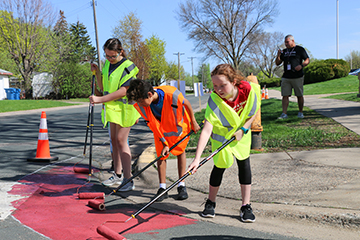 Students paint crosswalk for Safe Routes to School in South St. Paul.